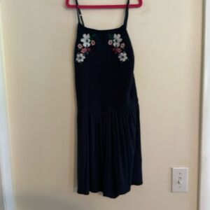Navy blue romper, Hollister size S, has a floral design at the top